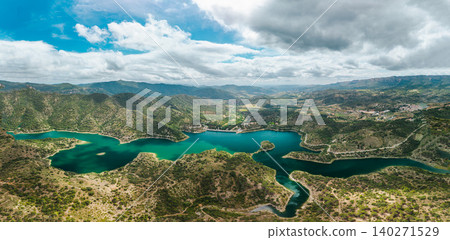 Panoramic aerial view of Siurana Reservoir and surrounding mountains in Catalonia, Spain. Emerald water winding through rugged valleys Panoramic aerial view of Siurana Reservoir and surrounding mountains in Catalonia, Spain. Emerald water winding through rugged valleys 140271529