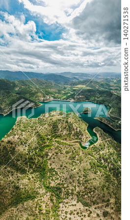 Vertical aerial view of Siurana Reservoir in Catalonia, Spain. Turquoise water winding through rugged mountains and dry Mediterranean terrain Vertical aerial view of Siurana Reservoir in Catalonia, Spain. Turquoise water winding through rugged mountains and dry Mediterranean terrain 140271538