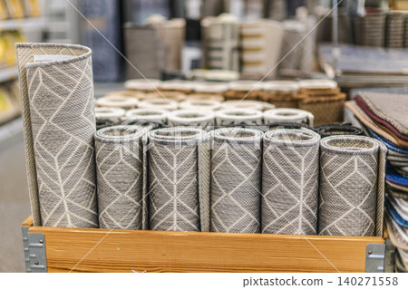 Rolled decorative rugs and floor mats displayed on shelves in home improvement store Rolled decorative rugs and floor mats displayed on shelves in home improvement store 140271558