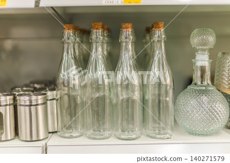 Glass bottles and decorative containers displayed on home decor store shelf Glass bottles and decorative containers displayed on home decor store shelf 140271579