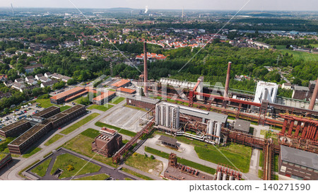 Aerial panorama of Zollverein Coal Mine Industrial Complex in Essen surrounded by urban district and green landscape in Germany Aerial panorama of Zollverein Coal Mine Industrial Complex in Essen surrounded by urban district and green landscape in Germany 140271590
