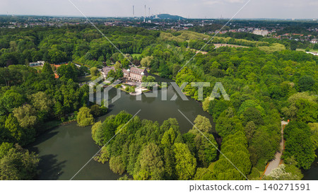 Aerial panorama of historic castle surrounded by lake and forest park near Essen in Germany Aerial panorama of historic castle surrounded by lake and forest park near Essen in Germany 140271591