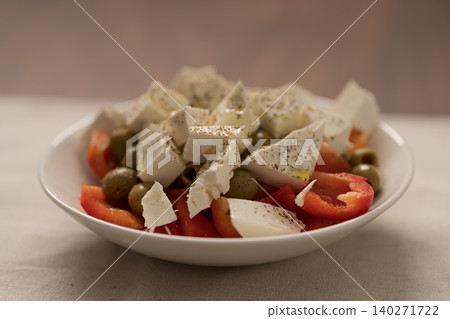 Greek style salad with tomatoes, bell pepper, olives and feta cheese Greek style salad with tomatoes, bell pepper, olives and feta cheese 140271722