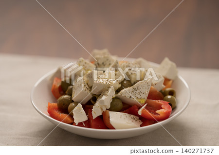 Greek style salad with tomatoes, bell pepper, olives and feta cheese Greek style salad with tomatoes, bell pepper, olives and feta cheese 140271737