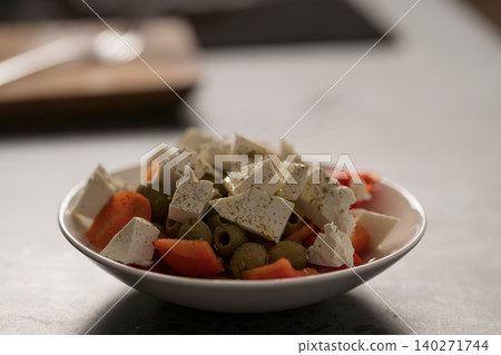 Greek style salad with tomatoes, bell pepper, olives and feta cheese 140271744