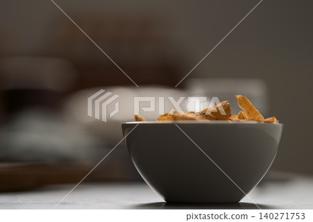 bowl of paprika potato chips closeup bowl of paprika potato chips closeup 140271753