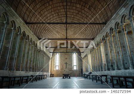 Serene and historic interior of Mont Saint-Michel Abbey with stone arches, ancient walls, and soft natural light filtering through narrow windows. Serene and historic interior of Mont Saint-Michel Abbey with stone arches, ancient walls, and soft natural light filtering through narrow windows. 140272594