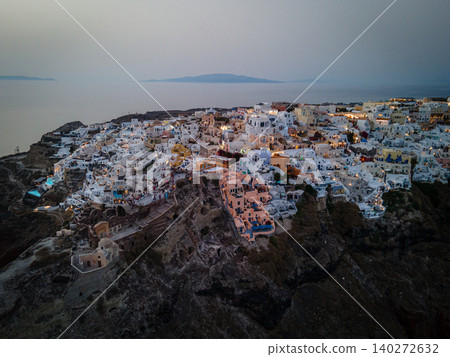 A breathtaking aerial view of the whitewashed village of Oia, Santorini, showcasing luxury resorts with infinity pools overlooking the Aegean Sea. A stunning blend of Cycladic architecture A breathtaking aerial view of the whitewashed village of Oia, Santorini, showcasing luxury resorts with infinity pools overlooking the Aegean Sea. A stunning blend of Cycladic architecture 140272632