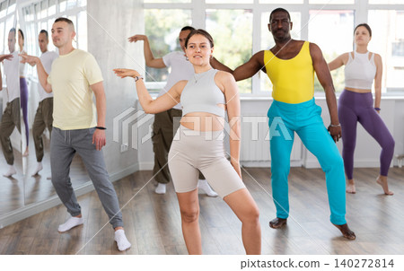 European girl with team of like-minded multinational people learn to elements of social dance 140272814