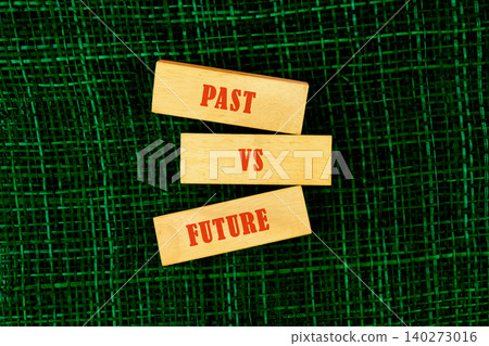 Wooden blocks display the words past and future, symbolizing the constant interplay between what has been and what lies ahead on a rich green backdrop that ignites thought Wooden blocks display the words past and future, symbolizing the constant interplay between what has been and what lies ahead on a rich green backdrop that ignites thought 140273016