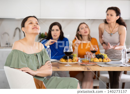 Group of women quarreling with asian woman Group of women quarreling with asian woman 140273137