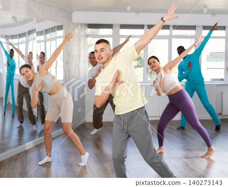 European guy with team of like-minded multinational people learn to elements of hip hop dance European guy with team of like-minded multinational people learn to elements of hip hop dance 140273143