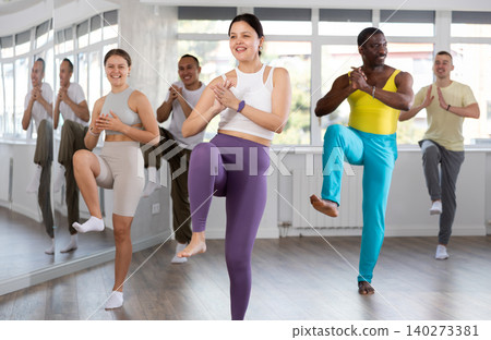 Young Asian woman practicing rhythmic aerobics at group workout Young Asian woman practicing rhythmic aerobics at group workout 140273381