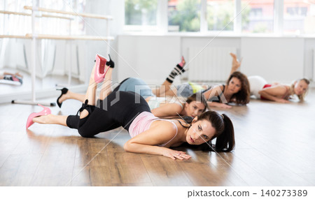 Female dancer mastering floorwork during high heels dance routine Female dancer mastering floorwork during high heels dance routine 140273389