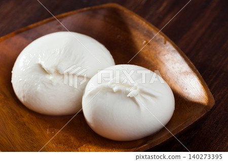 Burrata cheese and rukkola leaf closeup Burrata cheese and rukkola leaf closeup 140273395