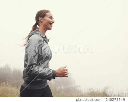 Nature, energy and woman running in fog on mountain road for race, marathon or competition training. Sports, exercise and athlete with cardio workout for fitness in misty outdoor woods or forest. Nature, energy and woman running in fog on mountain road for race, marathon or competition training. Sports, exercise and athlete with cardio workout for fitness in misty outdoor woods or forest. 140273549