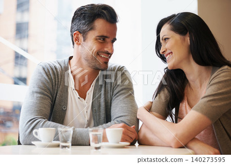 Love, talking and couple with coffee on date for romance or anniversary in cafeteria. Happy, bonding and young man and woman in conversation drinking latte, espresso or cappuccino at restaurant. Love, talking and couple with coffee on date for romance or anniversary in cafeteria. Happy, bonding and young man and woman in conversation drinking latte, espresso or cappuccino at restaurant. 140273595