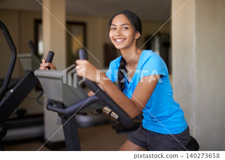 Woman, portrait and workout bike in gym, cycling and stationary machine for exercise or training. Happy female person, cardio and cycling for wellness, smile and equipment for fitness and health Woman, portrait and workout bike in gym, cycling and stationary machine for exercise or training. Happy female person, cardio and cycling for wellness, smile and equipment for fitness and health 140273658
