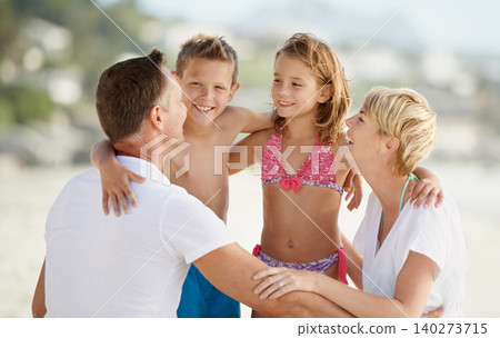 Parents, kids and happiness for bonding at beach on summer, holiday and hug in Florida. Family, children and circle in hot weather with smile, laugh and travel for vacation with trip and break. Parents, kids and happiness for bonding at beach on summer, holiday and hug in Florida. Family, children and circle in hot weather with smile, laugh and travel for vacation with trip and break. 140273715