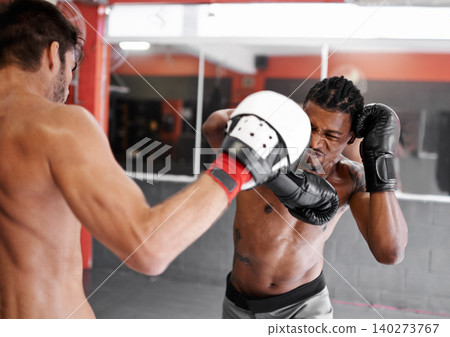 Boxer, coach and training with men for fitness, sport and boxing workout with personal trainer and athlete in gym. Exercise, skill and kickboxing with practice for MMA and challenge with action Boxer, coach and training with men for fitness, sport and boxing workout with personal trainer and athlete in gym. Exercise, skill and kickboxing with practice for MMA and challenge with action 140273767