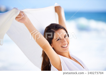 Portrait, happy woman and sarong in wind at beach outdoor for summer, vacation and travel on holiday. Ocean, smile and person fly with fabric in the air for freedom, breeze and face by water in Spain Portrait, happy woman and sarong in wind at beach outdoor for summer, vacation and travel on holiday. Ocean, smile and person fly with fabric in the air for freedom, breeze and face by water in Spain 140273784