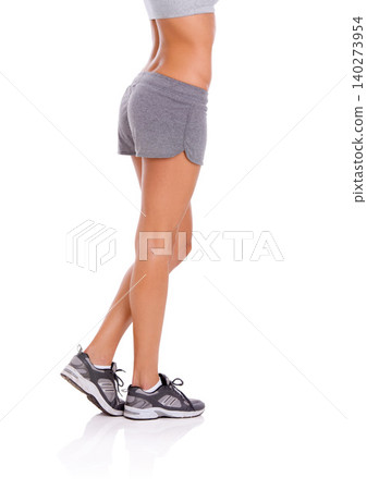 Woman, athlete and legs in studio with wellness for exercise, workout and healthy body with training shoes. Model, person and confidence with sportswear and shorts for fitness on white background Woman, athlete and legs in studio with wellness for exercise, workout and healthy body with training shoes. Model, person and confidence with sportswear and shorts for fitness on white background 140273954