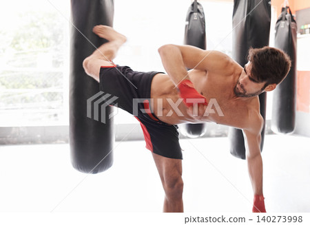 Man, boxing and bag kick as training exercise or cardio challenge or fitness practice, class or combat. Athlete, professional and gloves or workout performance in America or gym, strength or sport Man, boxing and bag kick as training exercise or cardio challenge or fitness practice, class or combat. Athlete, professional and gloves or workout performance in America or gym, strength or sport 140273998