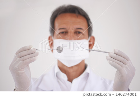 Portrait, dentist and man with tools, mask and expert advice for orthodontics in medical health. Dental medicine, healthcare and professional with pride, steel equipment and ppe for oral service. Portrait, dentist and man with tools, mask and expert advice for orthodontics in medical health. Dental medicine, healthcare and professional with pride, steel equipment and ppe for oral service. 140274001