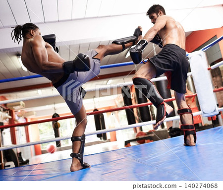 Kickboxing, fight and men training in gym for fitness and sport, coach and athlete with workout and action. Energy, challenge and MMA with athlete together in ring for boxing, exercise and endurance Kickboxing, fight and men training in gym for fitness and sport, coach and athlete with workout and action. Energy, challenge and MMA with athlete together in ring for boxing, exercise and endurance 140274068
