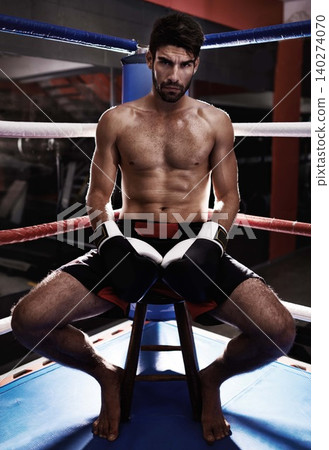 Man, portrait and boxer ready in ring for performance challenge, fight and match or competition. Male person, gloves and shirtless in arena for training, fitness and athlete for sitting in chair 140274070