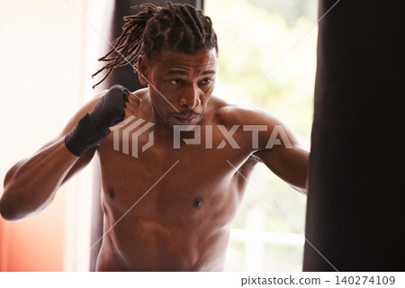 Fitness, punching bag and black man in gym for fight, exercise or boxing competition training. Power, muscle and serious champion boxer at workout with confidence, challenge and energy in sports club Fitness, punching bag and black man in gym for fight, exercise or boxing competition training. Power, muscle and serious champion boxer at workout with confidence, challenge and energy in sports club 140274109
