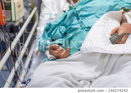 Hospital patient receiving intensive medical care monitoring equipment intravenous lines healthcare support critical care treatment environment 140274242