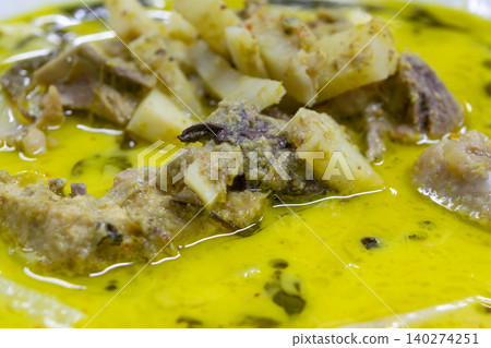 Close up of Thai green curry tender meat bamboo shoots rich coconut broth Traditional cuisine aromatic herbs vibrant color savory flavor Close up of Thai green curry tender meat bamboo shoots rich coconut broth Traditional cuisine aromatic herbs vibrant color savory flavor 140274251