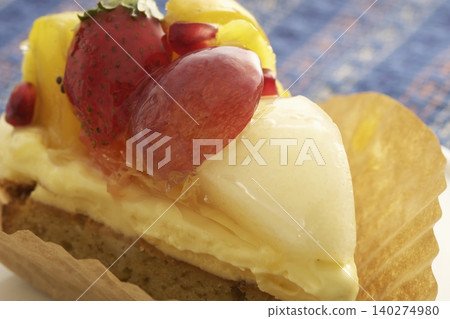 Fruit tart topped with strawberries, grapes, and pomegranates Fruit tart topped with strawberries, grapes, and pomegranates 140274980