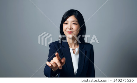A woman pressing a button in mid-air A woman pressing a button in mid-air 140275520