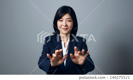 A woman typing on a screen in mid-air. 140275521