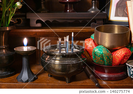 Incense and candles offered at the Buddhist altar Incense and candles offered at the Buddhist altar 140275774
