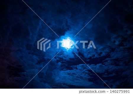 A blue moonlit sky shrouded in clouds A blue moonlit sky shrouded in clouds 140275991