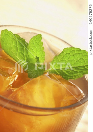 A refreshing iced tea garnished with mint. A refreshing iced tea garnished with mint. 140276276