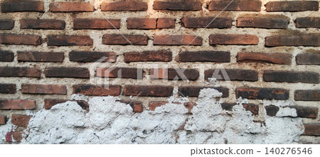Weathered brick wall with rough cement plaster texture background 140276546