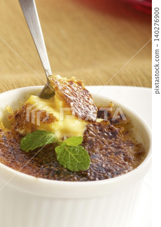 Crème brûlée served with a spoon Crème brûlée served with a spoon 140276900