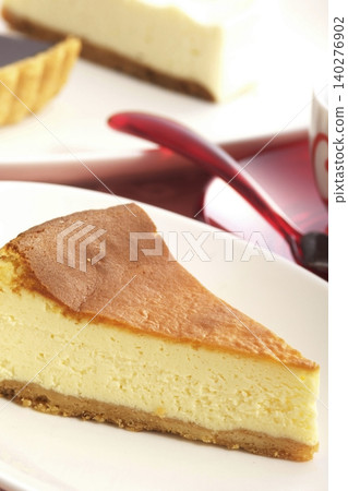 A slice of cheesecake on a white plate A slice of cheesecake on a white plate 140276902