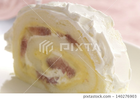 A slice of roll cake filled with cream and fruit. A slice of roll cake filled with cream and fruit. 140276903