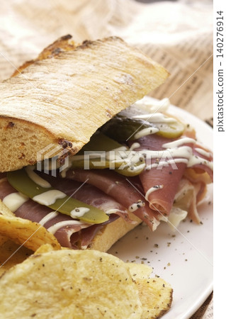 Ham and pickle sandwich with chips Ham and pickle sandwich with chips 140276914