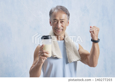 Senior man training with a protein bottle, fist pump 140277203