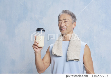 Senior man training with a protein bottle Senior man training with a protein bottle 140277204