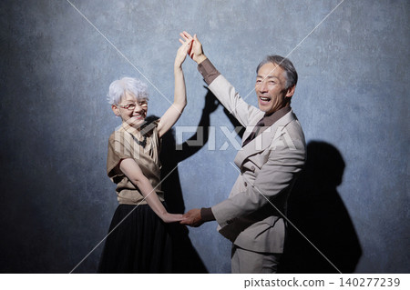 Senior couple enjoying dancing Senior couple enjoying dancing 140277239