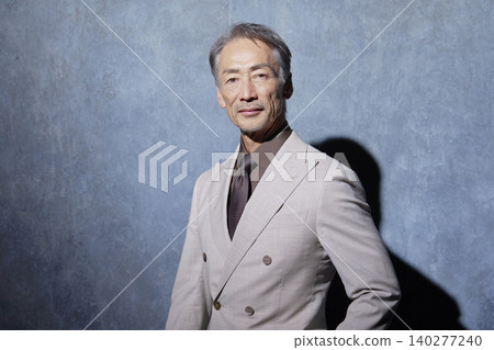 Portrait of a senior man in a suit on a black background Portrait of a senior man in a suit on a black background 140277240