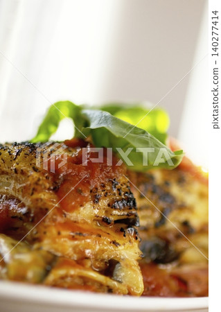 Freshly baked vegetable lasagna with tomato sauce and basil Freshly baked vegetable lasagna with tomato sauce and basil 140277414