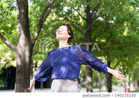 Young woman stretching in the shade Young woman stretching in the shade 140278150
